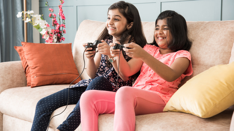 Two girls gaming on couch