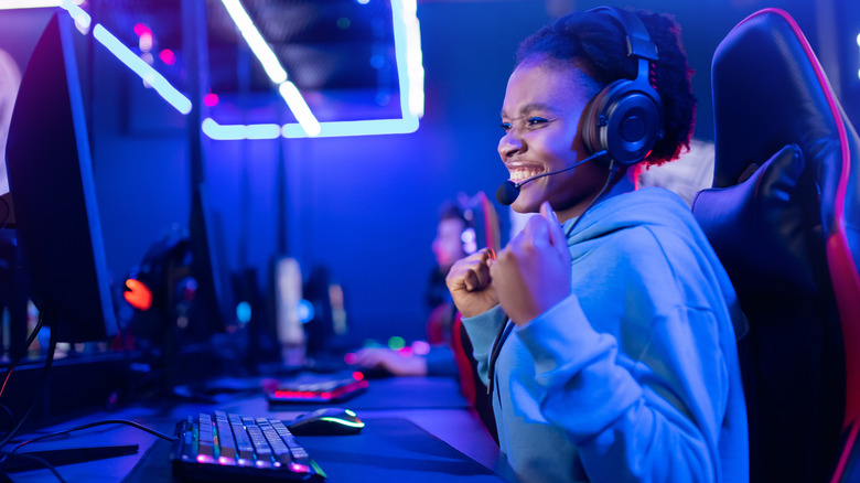 Young woman gamer smiling