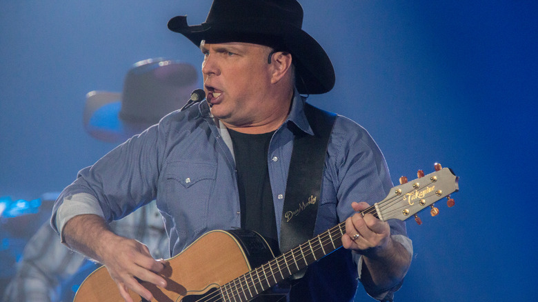 Garth Brooks singing on stage. 
