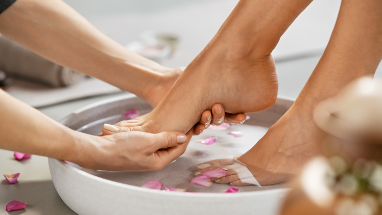 Woman soaking feet in pedicure