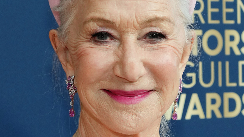 Helen Mirren wearing pink lipstick and smiling