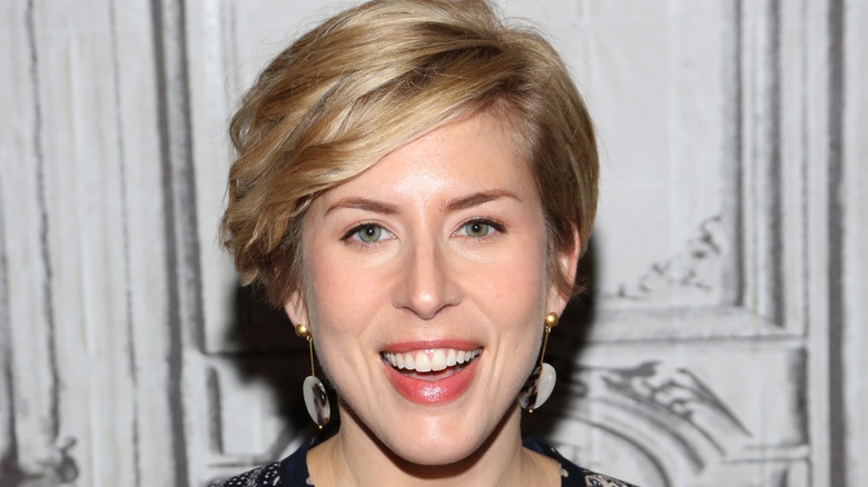 Erin Napier smiling while posing at an event