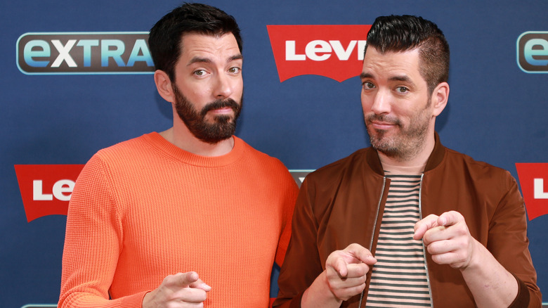 Drew and Jonathan Scott raising their eyebrows with a questioning look