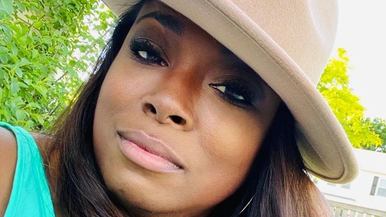 Tiffany Brooks takes a selfie in a hat
