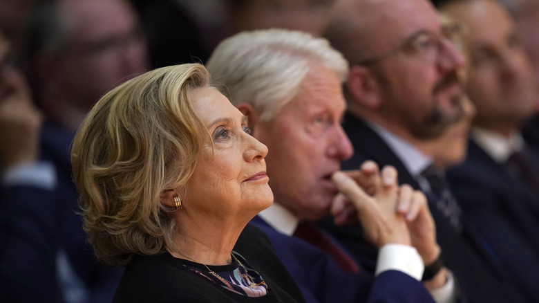 Hillary Clinton sitting with Bill Clinton