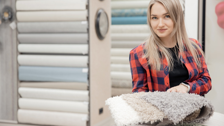 woman posing with carpet samples