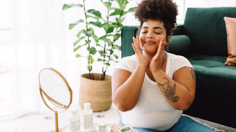 happy woman doing skincare routine