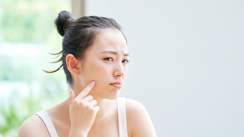 stressed woman touching skin