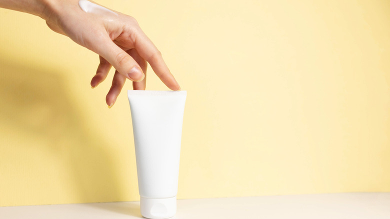 A hand touching a tube