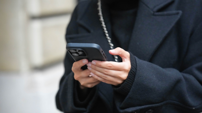 woman's hands texting