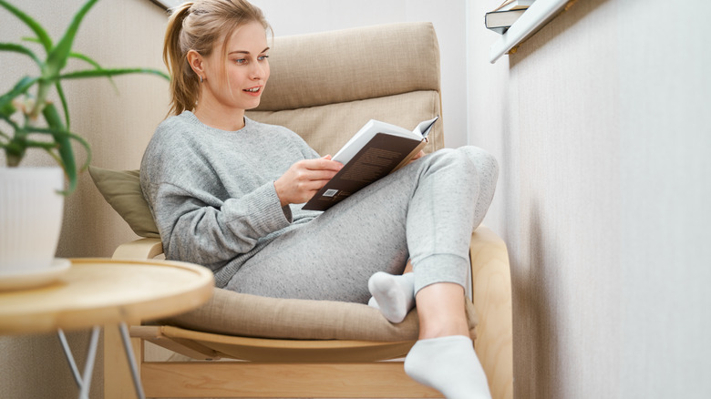 Woman reading on lounge chair