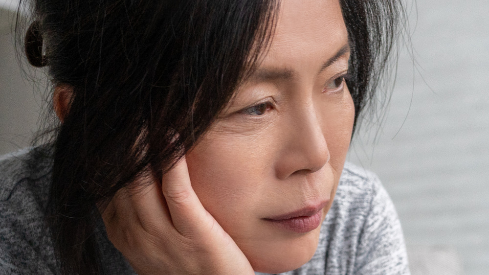 Women in grey shirt sitting alone