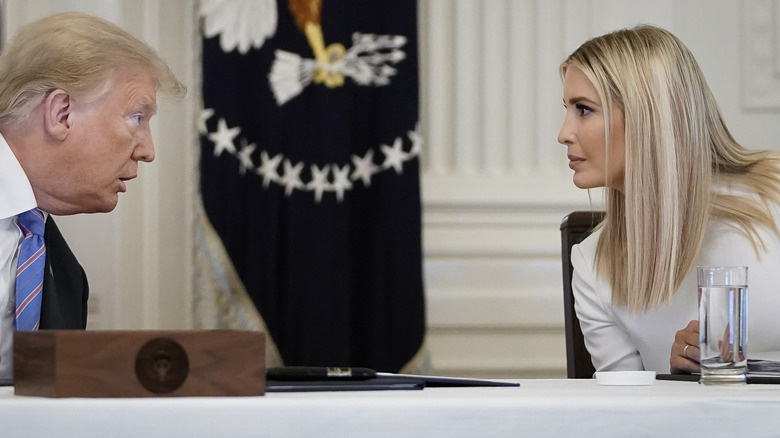 Donald and Ivanka Trump talking across table