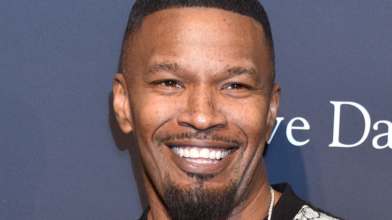 Jamie Foxx smiling on the red carpet.
