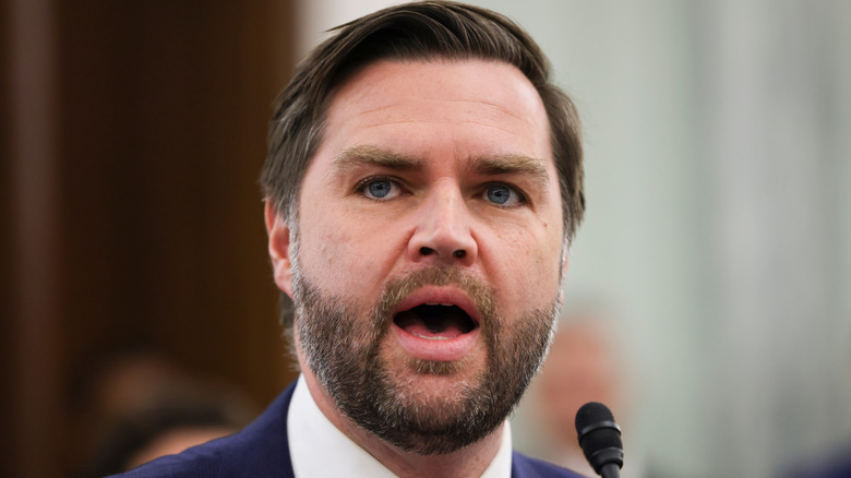 JD Vance speaking in a suit.