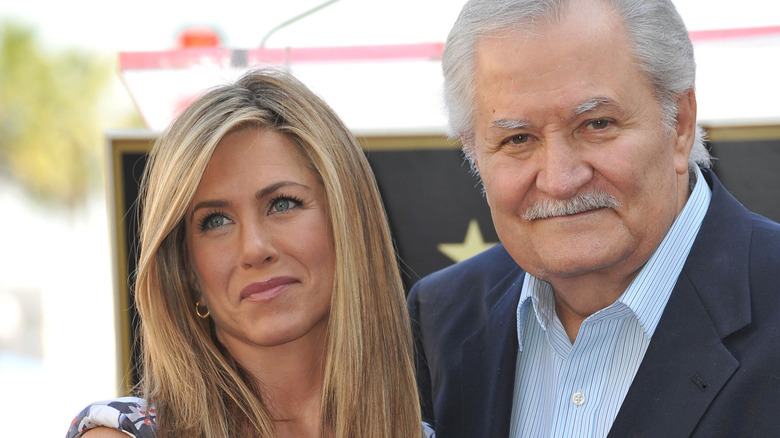 John and Jennifer Aniston smiling 