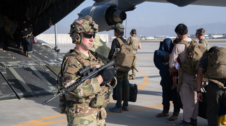 soldiers standing guard outside an evacuation flight