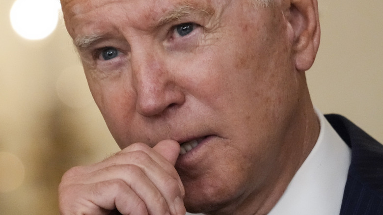 close up of Joe Biden with his hand to his mouth