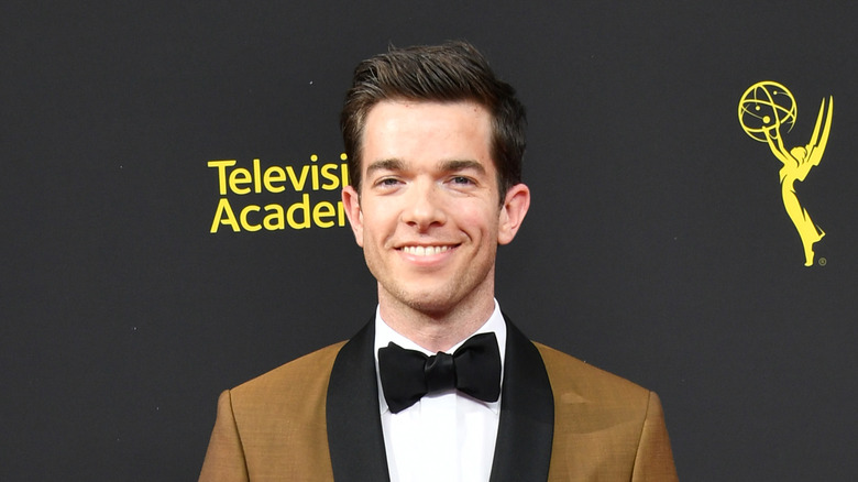 John Mulaney smiling on the red carpet