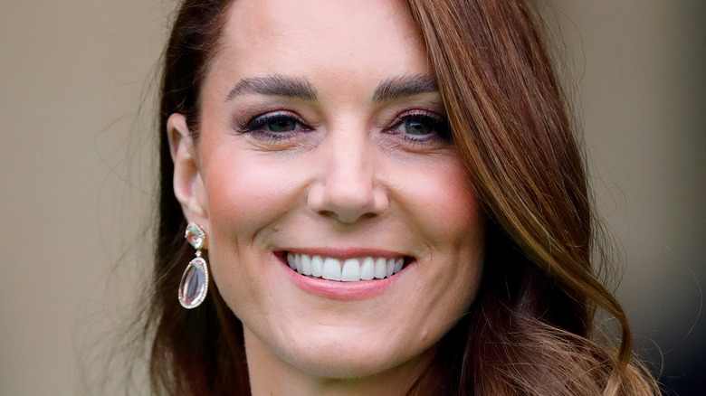 Kate Middleton smiles for a photo. 