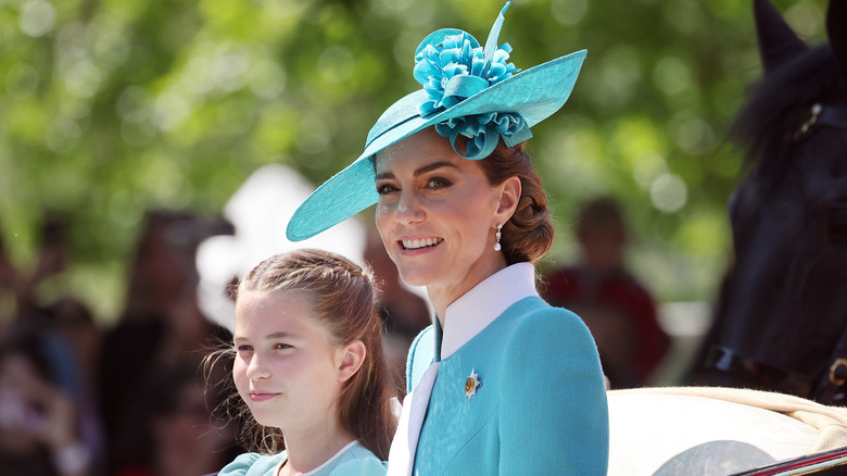 Kate Middleton and Princess Charlotte smiling in matching-colored outfits at Trooping the Colour 2025.