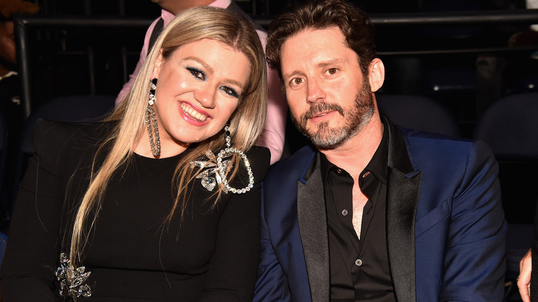 Brandon Blackstock and Kelly Clarkson posing for pics