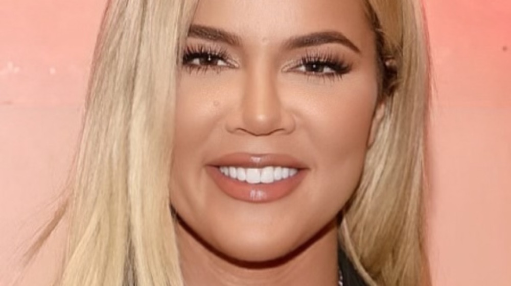 Khloe Kardashian smiling pink background
