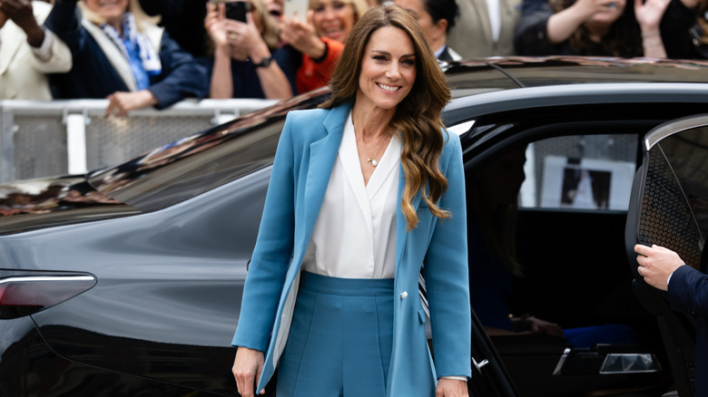 Princess Catherine smiling as adoring members of the public take photos of her