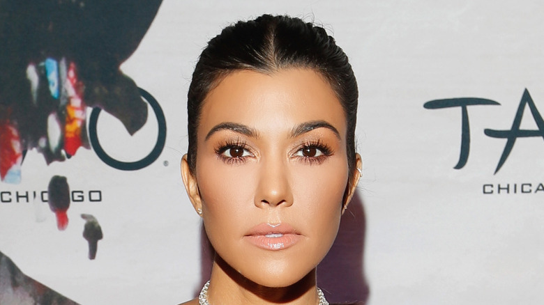 Kourtney Kardashian poses at an event