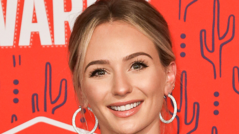 Lauren Bushnell smiling w/silver hoops on