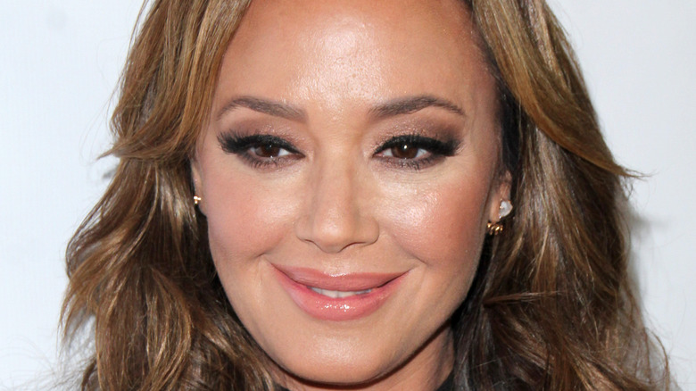 Leah Remini poses with a small smile