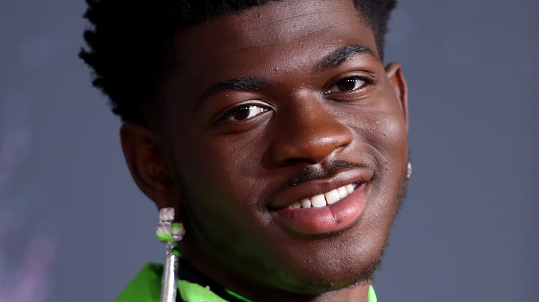 Lil Nas X smiles with head tilted