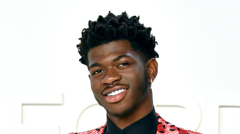 Lil Nas X smiles at an event
