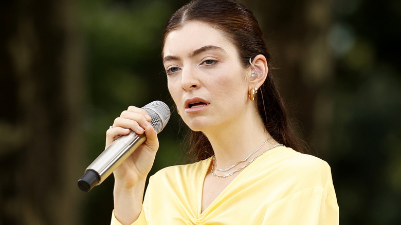 Lorde singing with microphone