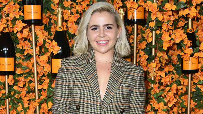 Mae Whitman poses at an event