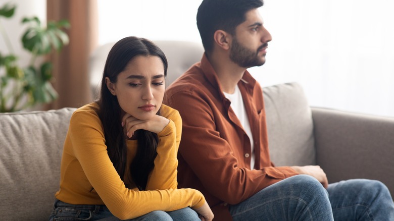 unhappy woman next to partner