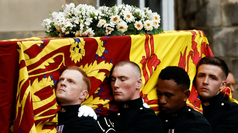 pallbearers carrying Queen Elizabeth's casket in Scotland
