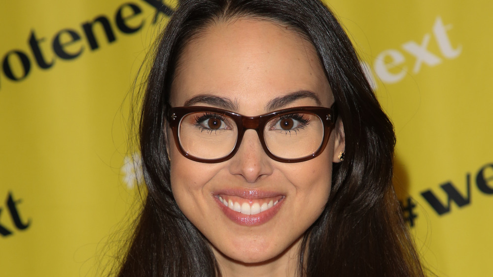 Meena Harris smiling in glasses