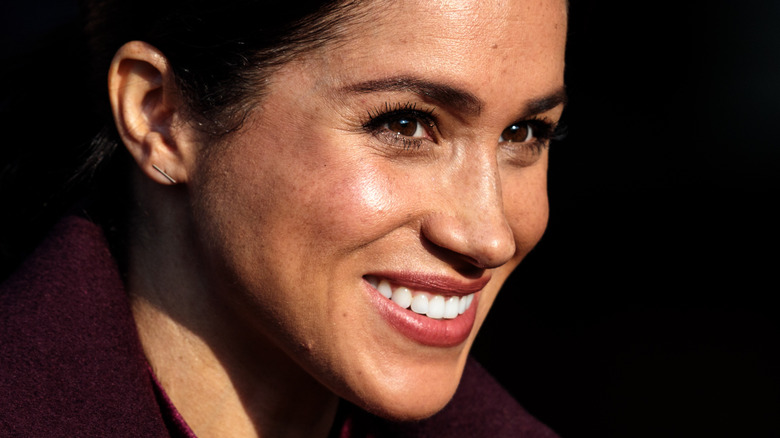 Meghan Markle smiles at an event.