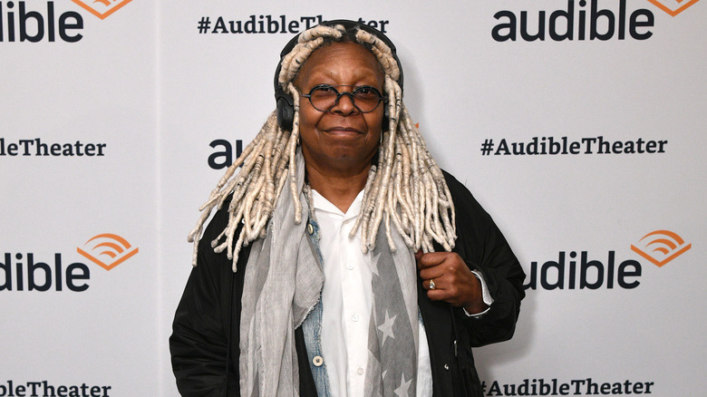 Whoopi Goldberg posing on red carpet