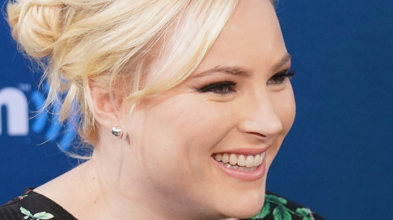 Meghan McCain smiling into mic