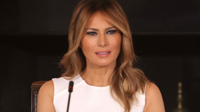 Melania Trump sitting in front of microphone