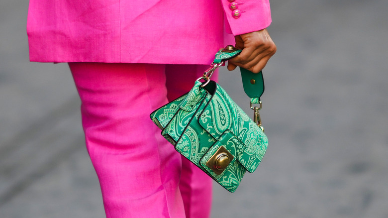 woman carries mini bag