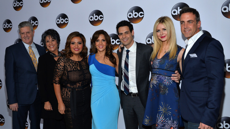 Justine Lupe posing with the cast of Cristela