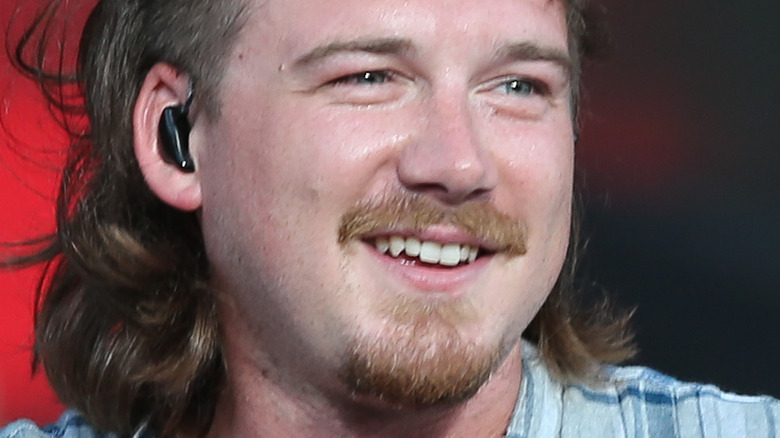 Morgan Wallen smiling on stage