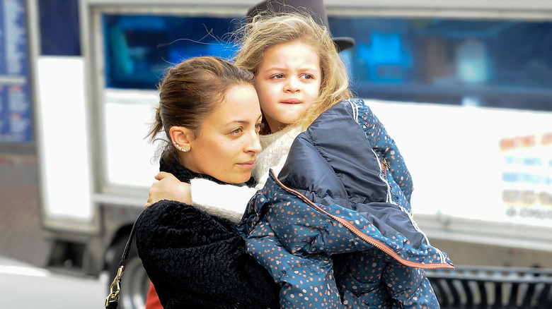 Nicole Richie carrying Harlow Madden