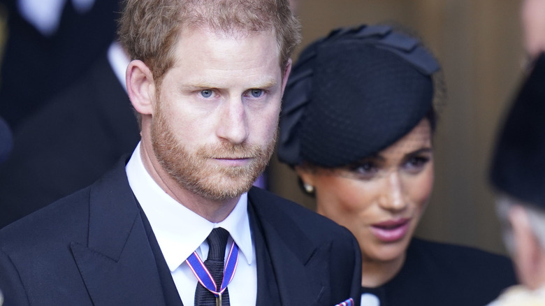 Meghan Markle and Prince Harry smiling at an event