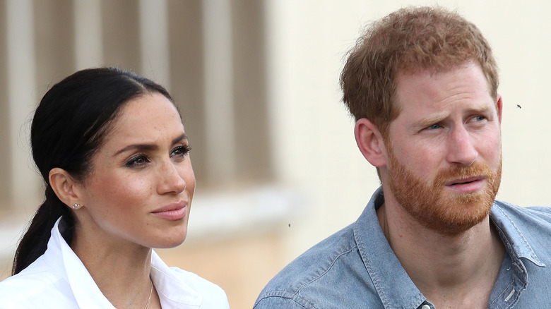 Meghan Markle and Prince Harry listening during an interview