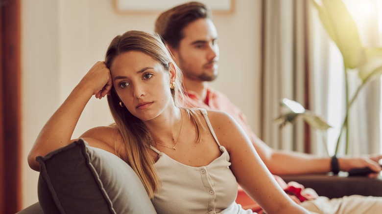 Woman with her back turned away from a man