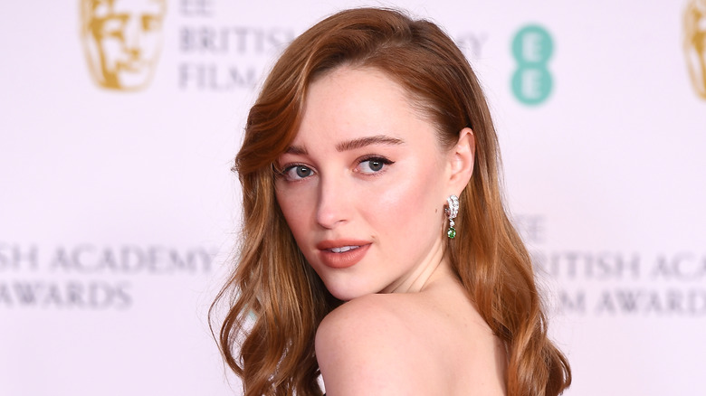 Phoebe Dynevor poses on the red carpet. 